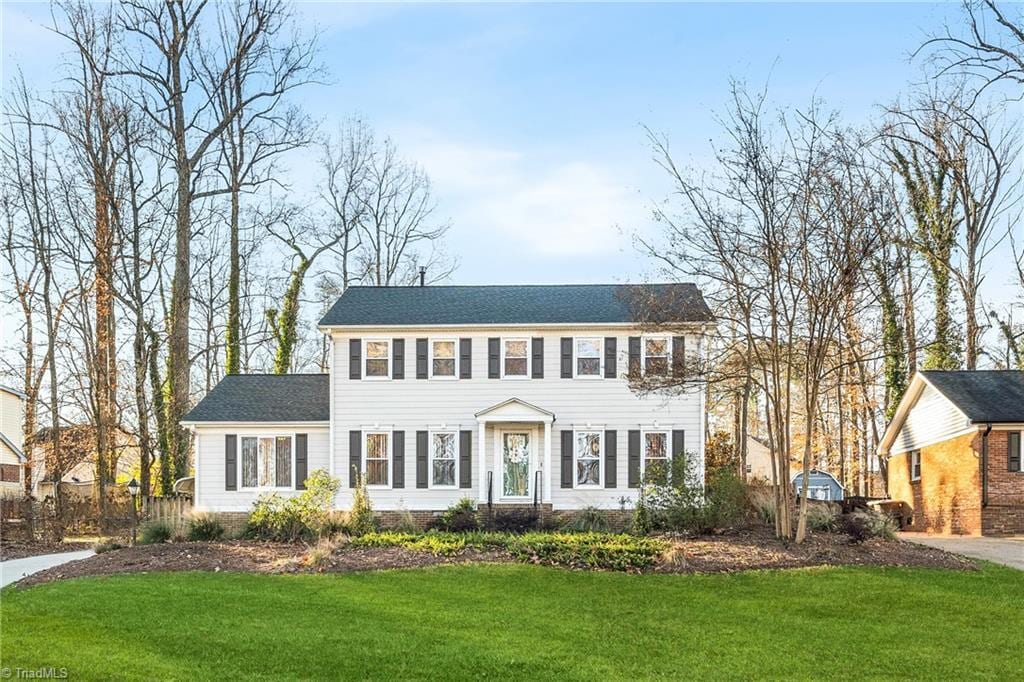 colonial-style house with a front yard