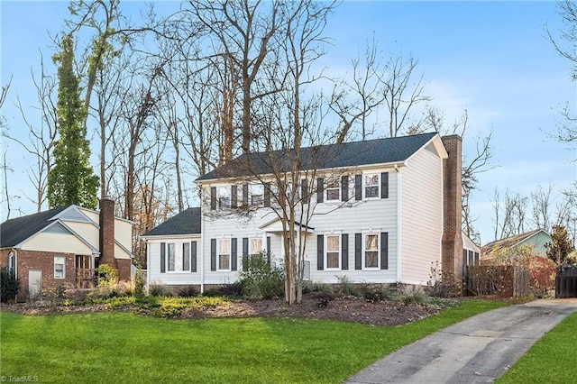 colonial home with a front lawn