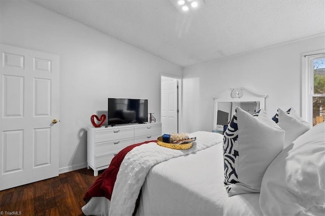 bedroom featuring dark wood-type flooring and vaulted ceiling