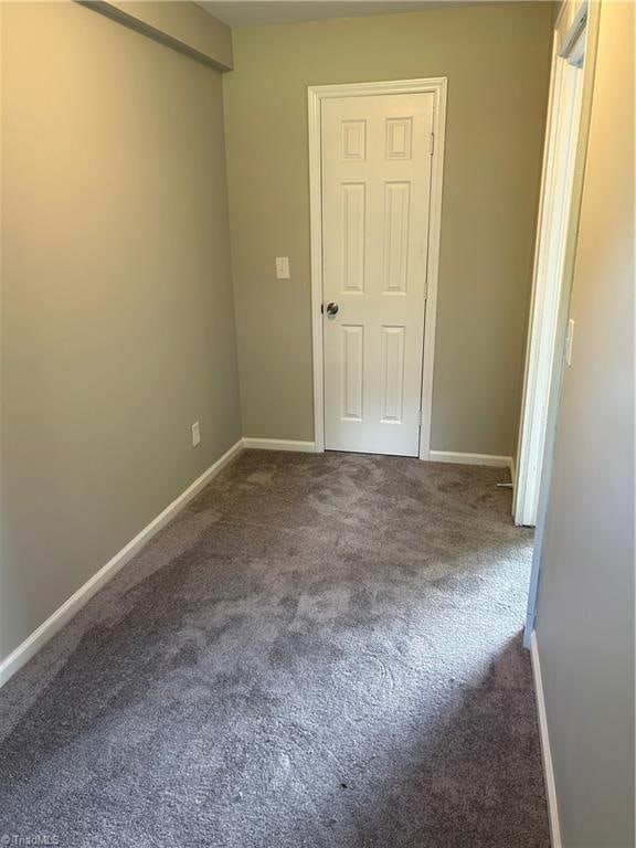 unfurnished room featuring carpet flooring