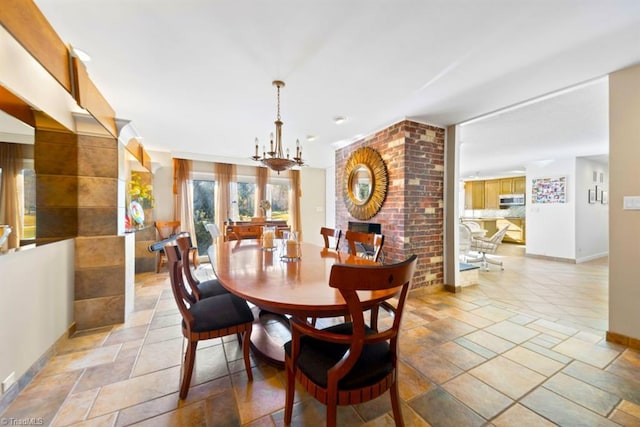 dining room featuring a notable chandelier and a fireplace