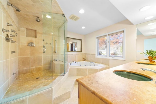 bathroom featuring tile patterned floors, vanity, and shower with separate bathtub