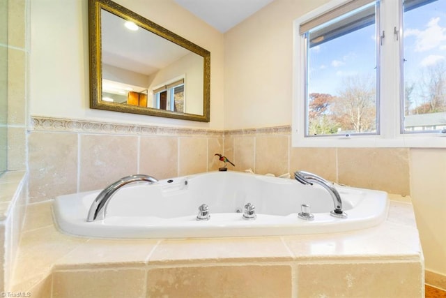 bathroom featuring tiled tub