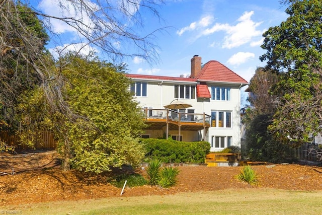 back of property featuring a wooden deck