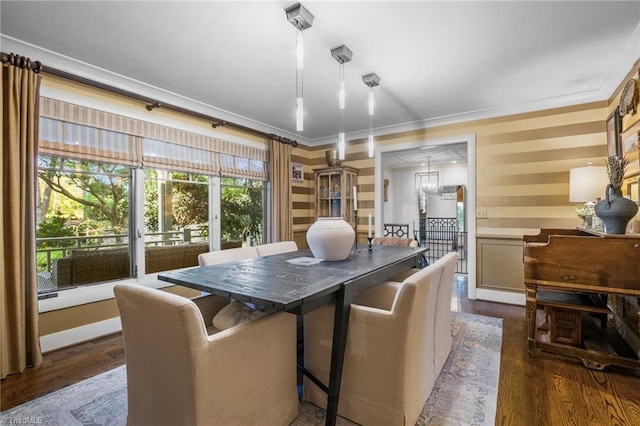 dining area featuring crown molding and dark hardwood / wood-style flooring