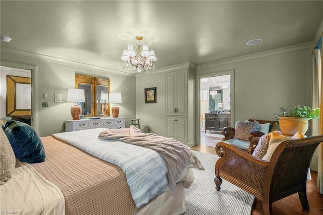 bedroom featuring crown molding, light hardwood / wood-style flooring, an inviting chandelier, and ensuite bath