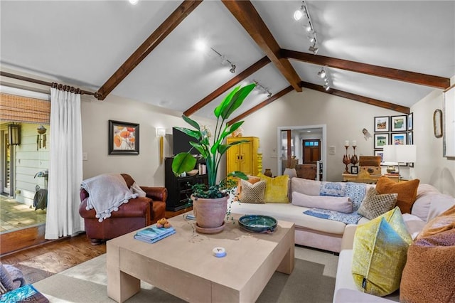 living room featuring track lighting, vaulted ceiling with beams, and light hardwood / wood-style floors