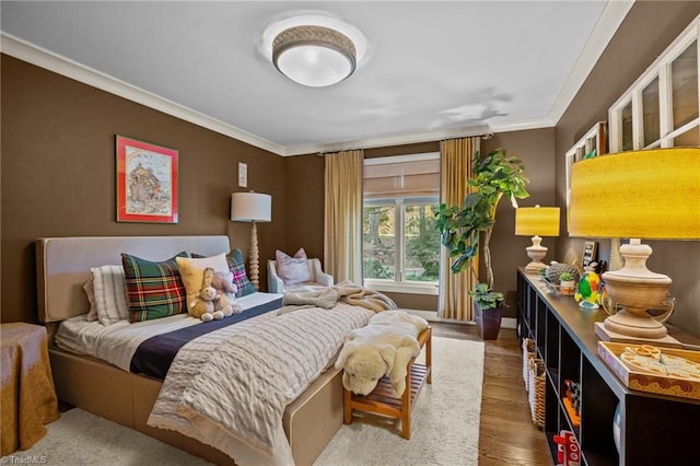 bedroom with crown molding and wood-type flooring