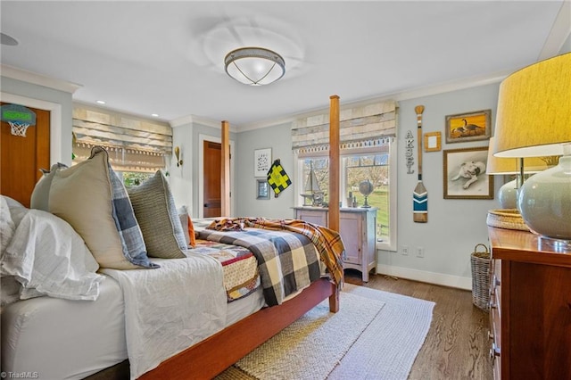 bedroom featuring light hardwood / wood-style floors, multiple windows, and crown molding