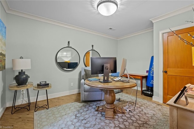 living area featuring crown molding and hardwood / wood-style floors