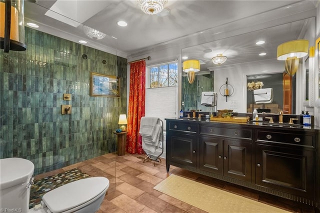 bathroom featuring tile walls, vanity, a shower, and toilet