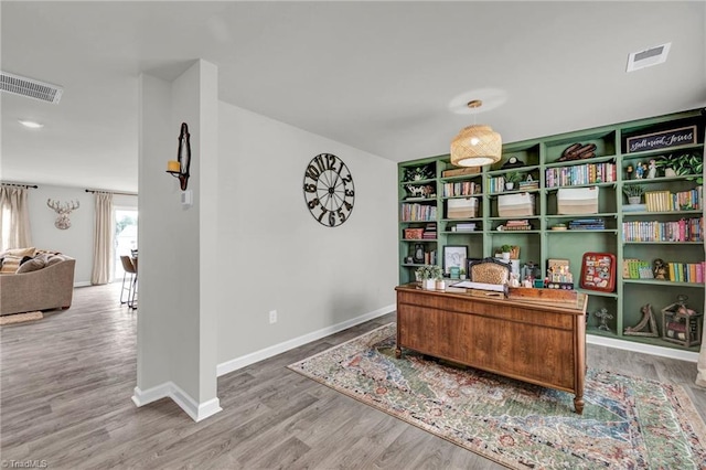 office space with wood-type flooring