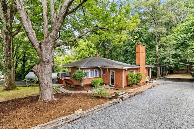 single story home featuring a carport and a deck