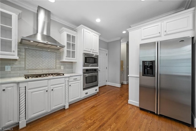 4803 Bluff Run Dr, Greensboro, NC 27455 - kitchen featuring appliances with stainless steel finishes, wall chimney range hood, ornamental molding, white cabinetry, and recessed lighting