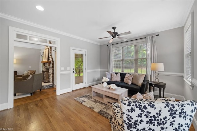 4803 Bluff Run Dr, Greensboro, NC 27455 - living area with plenty of natural light, crown molding, wood finished floors, a ceiling fan, and baseboards