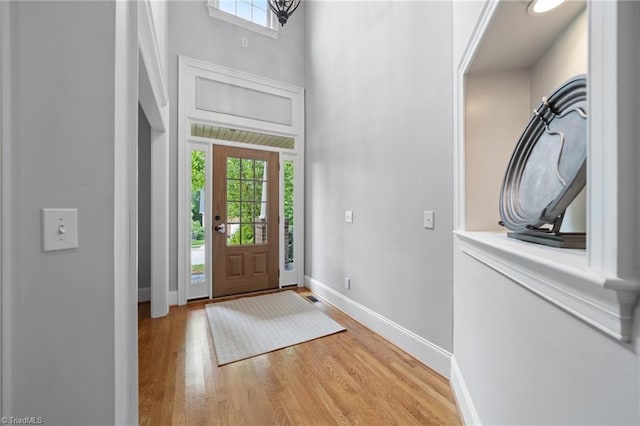 4803 Bluff Run Dr, Greensboro, NC 27455 - foyer entrance with a towering ceiling, light wood-style floors, and baseboards