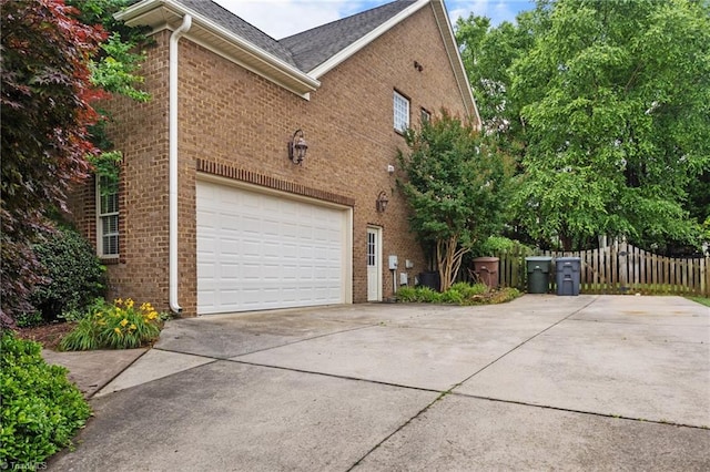4803 Bluff Run Dr, Greensboro, NC 27455 - view of side of home featuring brick siding, driveway, and a garage