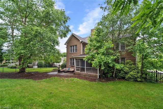 4803 Bluff Run Dr, Greensboro, NC 27455 - rear view of property with a sunroom, brick siding, and a patio area