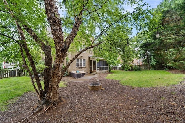 4803 Bluff Run Dr, Greensboro, NC 27455 - view of yard featuring a sunroom, a patio area, and an outdoor fire pit