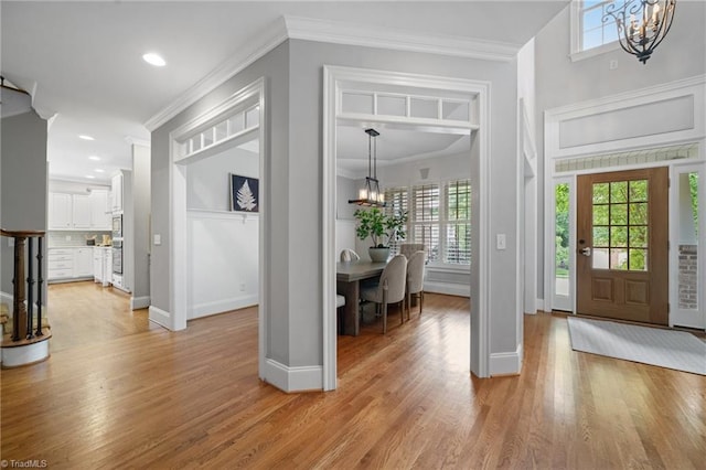 4803 Bluff Run Dr, Greensboro, NC 27455 - entrance foyer featuring a chandelier, healthy amount of natural light, light wood-style flooring, crown molding, and recessed lighting