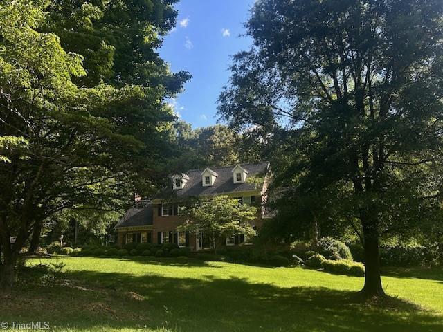 5002 Leadenhall Rd, Oak Ridge, NC 27310 - view of front facade with a front yard