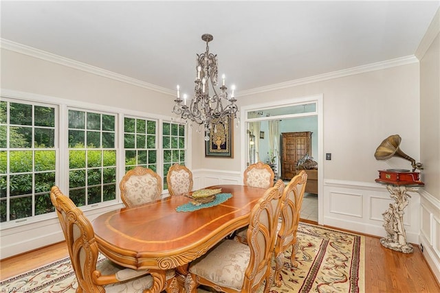 5002 Leadenhall Rd, Oak Ridge, NC 27310 - dining room featuring a chandelier, ornamental molding, plenty of natural light, light wood-style floors, and wainscoting