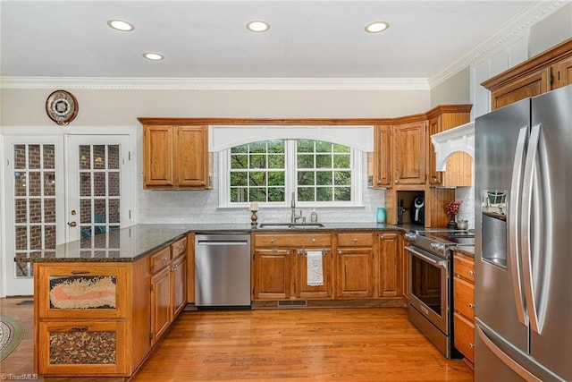 5002 Leadenhall Rd, Oak Ridge, NC 27310 - kitchen with appliances with stainless steel finishes, a sink, brown cabinetry, decorative backsplash, and crown molding