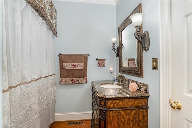 5002 Leadenhall Rd, Oak Ridge, NC 27310 - bathroom featuring vanity, wood finished floors, and baseboards