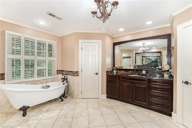 5002 Leadenhall Rd, Oak Ridge, NC 27310 - full bathroom featuring a chandelier, a freestanding bath, vanity, tile walls, and ornamental molding