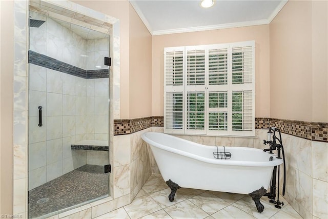 5002 Leadenhall Rd, Oak Ridge, NC 27310 - bathroom featuring tile walls, crown molding, a freestanding tub, a stall shower, and a wainscoted wall
