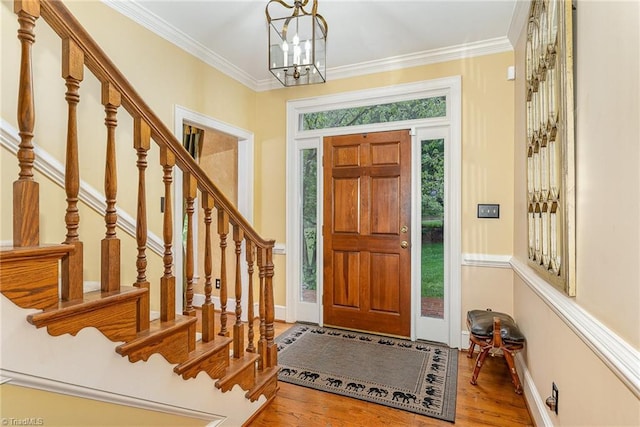 5002 Leadenhall Rd, Oak Ridge, NC 27310 - foyer with wood finished floors, a chandelier, stairs, baseboards, and ornamental molding