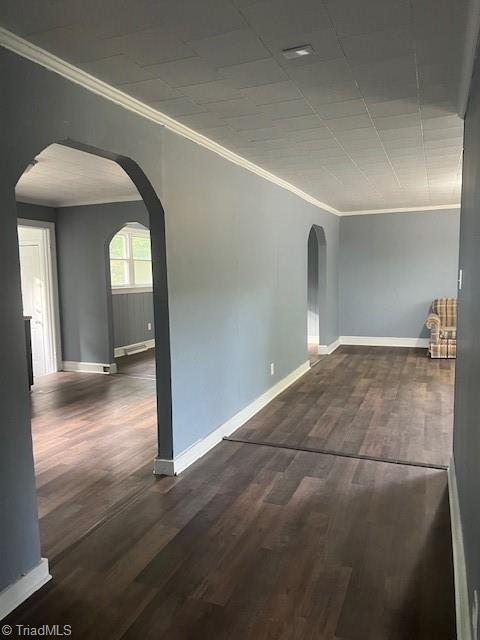 unfurnished room featuring dark hardwood / wood-style flooring and ornamental molding