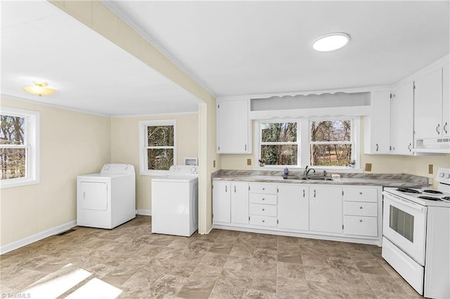 laundry area featuring crown molding, baseboards, washer and clothes dryer, laundry area, and a sink