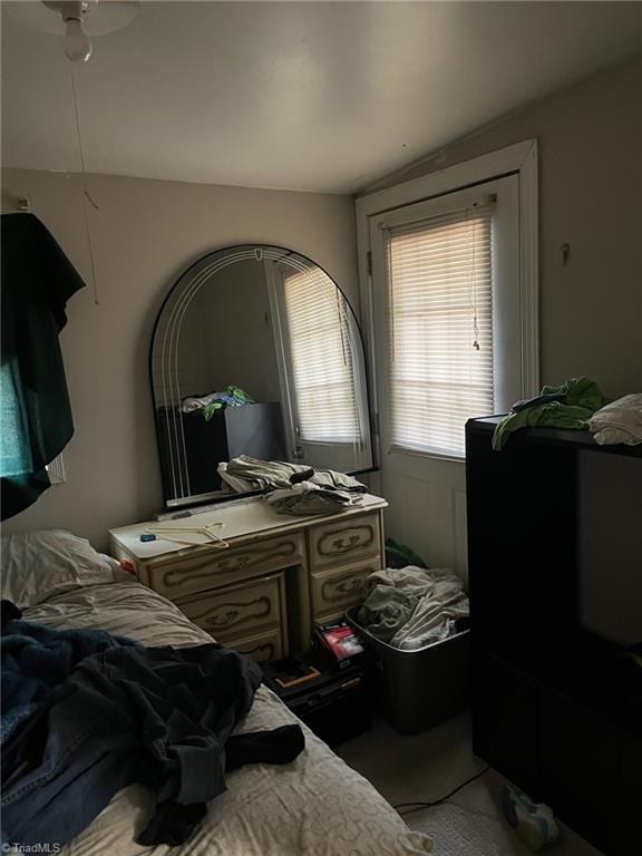 bedroom featuring ceiling fan and vaulted ceiling