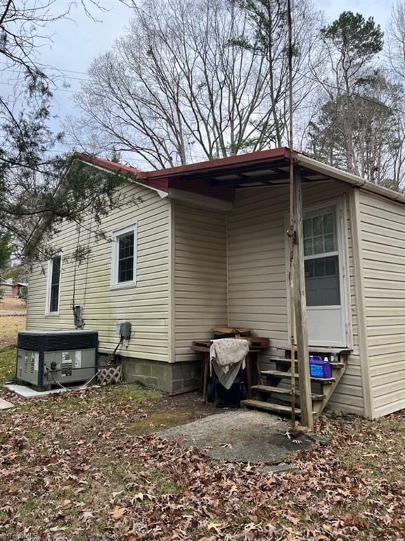 rear view of property featuring central air condition unit