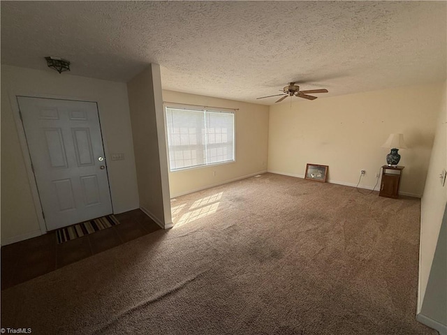 carpeted entrance foyer with baseboards, a textured ceiling, and ceiling fan