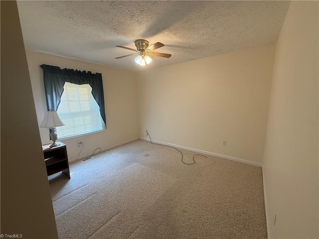 empty room featuring visible vents, carpet flooring, baseboards, a textured ceiling, and a ceiling fan