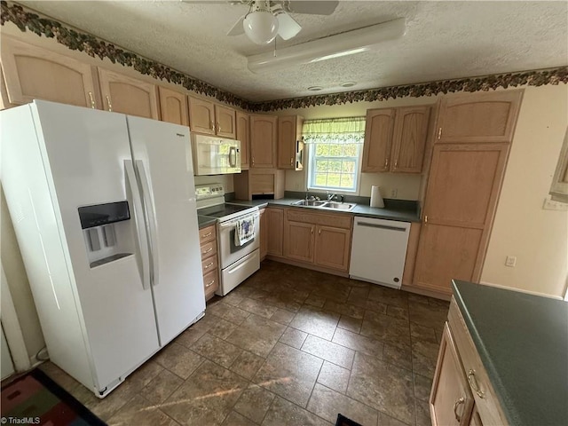 kitchen featuring a ceiling fan, dark countertops, white appliances, a textured ceiling, and a sink