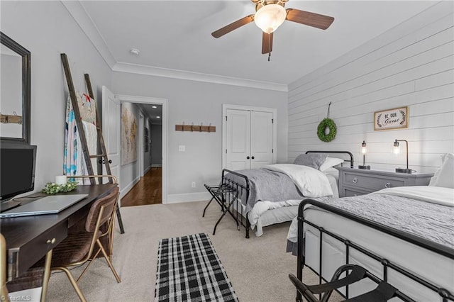 7823 Gatsby Pl, Greensboro, NC 27455 - bedroom with wooden walls, crown molding, a closet, light colored carpet, and a desk