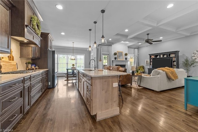 7823 Gatsby Pl, Greensboro, NC 27455 - kitchen with a breakfast bar area, a ceiling fan, dark wood-style flooring, beam ceiling, and dark brown cabinetry