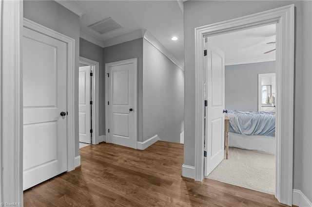 7823 Gatsby Pl, Greensboro, NC 27455 - corridor featuring dark wood finished floors, ornamental molding, and recessed lighting
