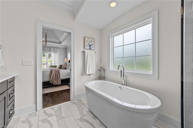 7823 Gatsby Pl, Greensboro, NC 27455 - bathroom featuring marble finish floors, a freestanding bath, vanity, ensuite bathroom, and crown molding