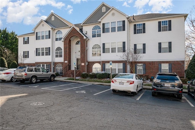 view of building exterior featuring uncovered parking