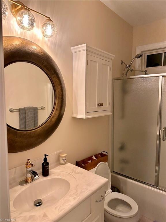 full bathroom with vanity, toilet, and shower / bath combination with glass door