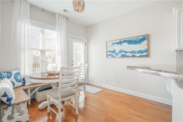 dining space with light hardwood / wood-style flooring