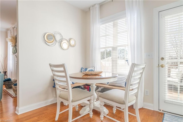 dining space with light hardwood / wood-style floors