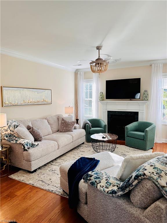 living room with hardwood / wood-style flooring and ornamental molding