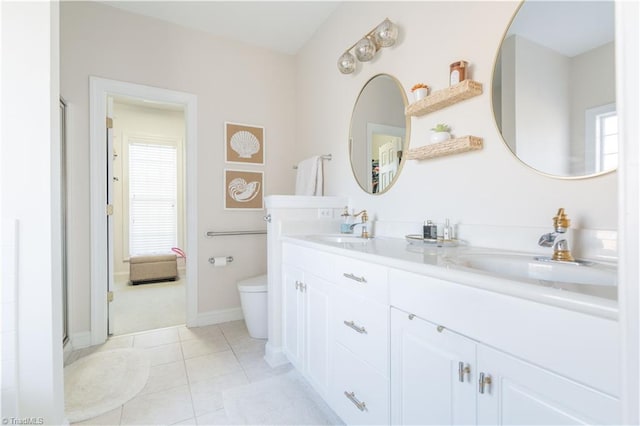 bathroom featuring tile patterned flooring, vanity, and toilet