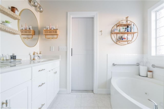 bathroom with tile patterned floors, vanity, and a tub to relax in