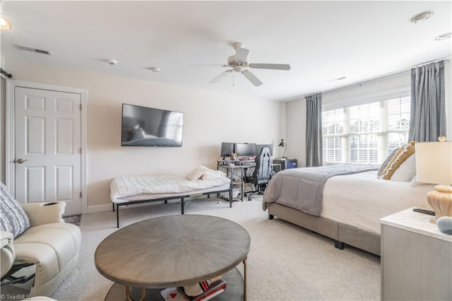 bedroom featuring ceiling fan and light carpet